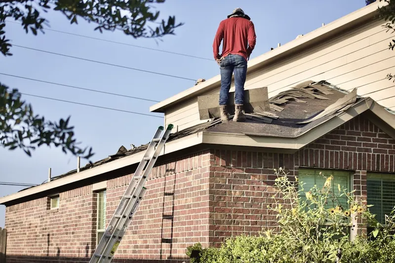 Professional roofer working on a residential roof in Neuse